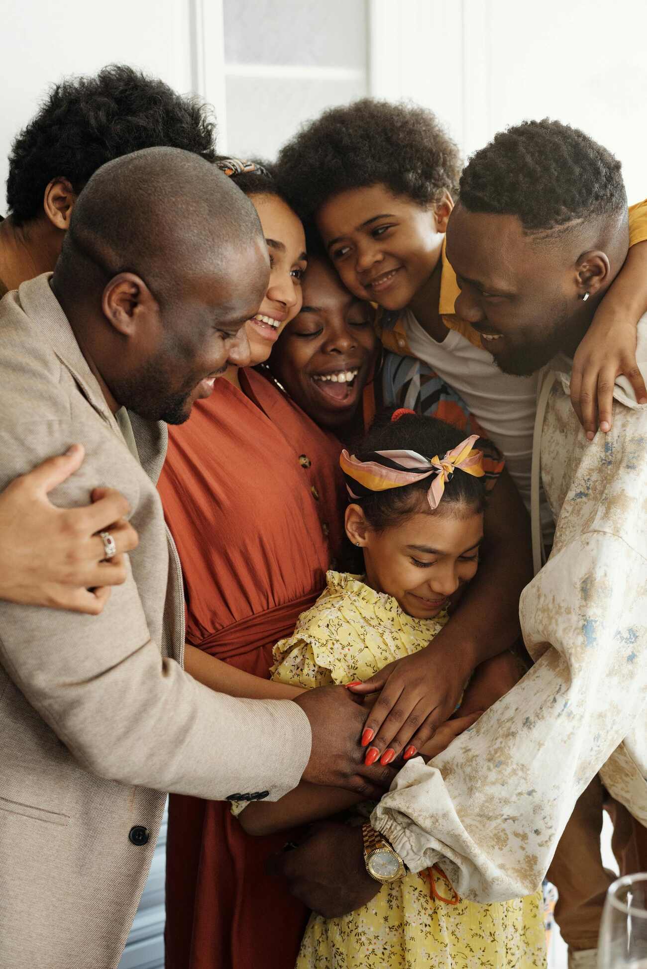 A happy family embracing each other with smiles on their faces